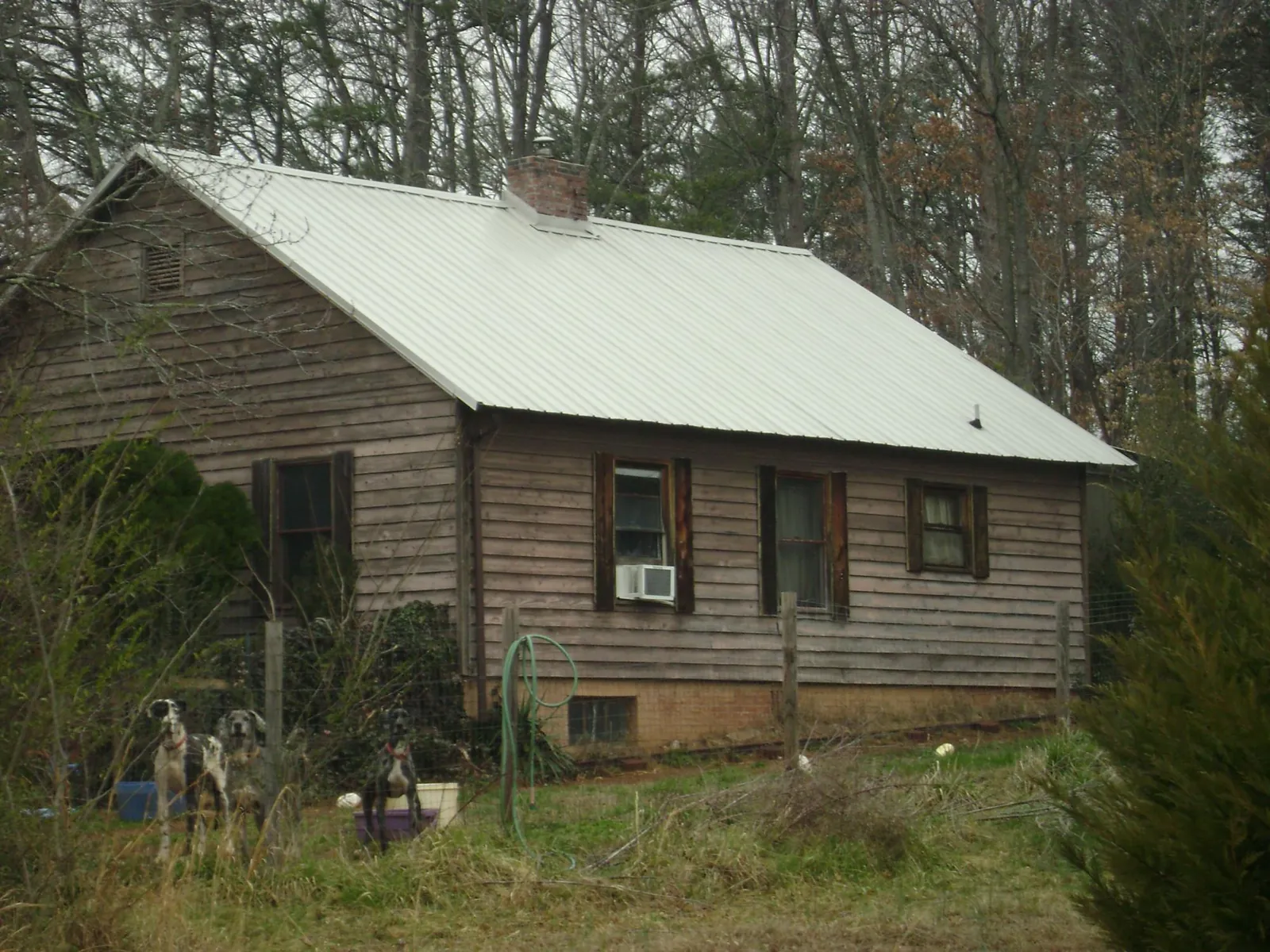 White metal roof on an old wood sided farmhouse, from a Metal Roof Installation job in Wildwood